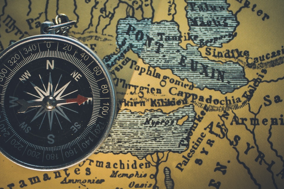 Vintage compass on an antique map for the Infiltrated escape room